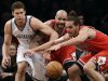 Brooklyn Nets center Brook Lopez (11), Chicago Bulls forward Carlos Boozer, center, and center Joakim Noah, right, compete for a loose ball in the first half of Game 5 of their first-round NBA basketball playoff series, Monday, April 29, 2013, in New York. (AP Photo/Kathy Willens)