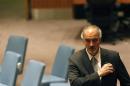 Syria's U.N. Ambassador Bashar Ja'afari walks through the hall during the U.N. Security Council meeting on Syria in New York