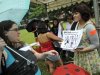 Volunteer Vanessa Liew, right, shows Crystal Nanavati a flyer in support of the "SlutWalk" movement at Hong Lim Park in Singapore Sunday, Dec. 4, 2011. Singaporeans gathered at the downtown park to protest sexual violence against women as part of the global "SlutWalk" movement. (AP Photo/Bryan van der Beek)