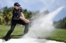 James Driscoll of the U.S. hits the ball out of the bunker on the 18th hole during the third round of the Puerto Rico Open PGA golf tournament in Rio Grande, Puerto Rico, Saturday, March 7, 2015. (AP Photo/Ricardo Arduengo)