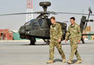 Britain's Prince Harry is shown the Apache flight-line Friday Sept 7 2012 by a member of his squadron (name not provided) at Camp Bastion in Afghanistan, where he will be operating from during his tour of duty as a co-pilot gunner. The Prince has returned to Afghanistan to fly attack helicopters in the fight against the Taliban. (AP Photo/ John Stillwell, Pool)