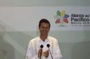 Mexico's President Enrique Pena Nieto applauds after the signing of agreements at the second day of the 2014 Alianza del Pacifico political summit in Punta Mita