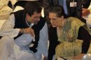 Gandhi a lawmaker speaks to Sonia Gandhi, who is his mother and India's ruling Congress party chief, during the Indian National Congress meeting in Jaipur
