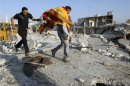 A man carries the body of a boy after a Syrian Air force air strike in Azaz