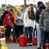 As temperatures begin to drop, people wait in line to fill containers with gas at a Shell gasoline filling station Thursday, Nov. 1, 2012, in Keyport, N.J. In parts of New York and New Jersey, drivers lined up Thursday for hours at gas stations that were struggling to stay supplied. The power outages and flooding caused by Superstorm Sandy have forced many gas stations to close and disrupted the flow of fuel from refineries to those stations that are open. (AP Photo/Mel Evans)