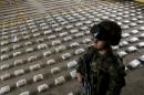 A Colombian Army soldier stands next to packages of seized cocaine, which according to authorities, belonged to the criminal gang "Clan Usuga" and was going to be sent to Central America, at a Military Base in Bahia Solano, Colombia on March 14, 2015