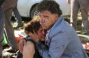 An injured man hugs an injured woman after an explosion during a peace march in Ankara