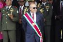FILE - In this Aug. 12, 2015 file photo, Suriname President Desire Delano Bouterse observes a military parade, after being sworn in for his second term, in Paramaribo, Suriname. A military court in Suriname on Monday, Jan. 30, 2017, ordered the president to resume his long-stalled murder trial in the killing of political opponents under his dictatorship in 1982. (AP Photo/Ertugrul Kilic, File)