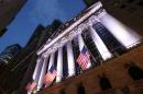 In this Oct. 8, 2014 photo, American flags fly in front of the New York Stock Exchange, in New York. U.S. stocks are rising in early trading Tuesday, Jan. 13, 2015, following two days of declines. (AP Photo/Mark Lennihan)