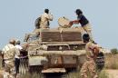 Fighters from the pro-government forces loyal to Libya's Government of National Unity (GNA) are seen around a tank on July 2, 2016 as they take position to hit Islamic State (IS) group targets in Sirte
