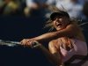 Sharapova of Russia hits a return to Azarenka of Belarus during their women's semifinals match at the U.S. Open tennis tournament in New York