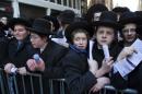 Participants wait as they and thousands of Orthodox Jews gather in New York, Sunday, March 9, 2014, on Water Street in lower Manhattan, to pray and protest against the Israeli government's proposal to pass a law that would draft strictly religious citizens into its army. (AP Photo/Craig Ruttle)