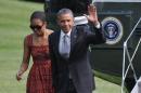 US President Barack Obama and First Lady Michelle Obama return to the White House on June 16, 2014 in Washington, DC