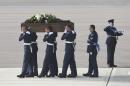 Pallbearers carry a coffin from a British RAF C-17 plane, confirmed as carrying the body of Adrian Evans, as the bodies of eight British nationals killed Friday in the Tunisia beach terror attack at RAF Brize Norton, England, Wednesday July 1, 2015. At least 27 Britons are confirmed among the 38 people shot dead when a Tunisian student opened fire on a beach in the North African nation's central resort of Sousse. (Joe Giddens / Pool photo via AP)