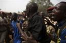 A man pushes a Gendarmerie officer away from an angry crowd in the capital Bangui