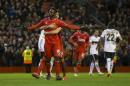 Liverpool's Mario Balotelli, left, celebrates with teammate Emre Can after scoring a penalty during the Europa League Round of 32 soccer match between Liverpool and Besiktas at Anfield Stadium in Liverpool, England, Thursday, Feb. 19, 2015. (AP Photo/Jon Super)