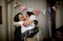 Iranian lawyer Nasrin Sotoudeh (C ) hugs her mother-in-law at her house in Tehran on September 18, 2013