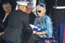 A Marine honor guard presents 82-year-old Josephine "Dody" Demianenko, the U.S. flag that had been draped over her brother's casket after a burial service for Marine Pfc. John Albert Donovan at the Old St. Patrick Catholic Church cemetery in Northfield Township, Mich., Friday, June 8, 2012. Nearly seven decades after Donovan went missing following a World War II bomber crash, Donovan was laid to rest in Michigan. His remains were identified this year. (AP Photo/Carlos Osorio)