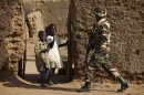 Children wave at a soldier from Niger on patrol in Gao