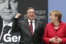 German Chancellor Angela Merkel, right, and former German Chancellor Gerhard Schroeder, left, pose during a photo call for the book presentation of Schroeder's biography in Berlin, Germany, Tuesday, Sept. 22, 2015. (AP Photo/Michael Sohn)