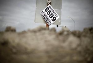 A sign advertising bankruptcy filing is seen hanging off a road sign in San Bernardino