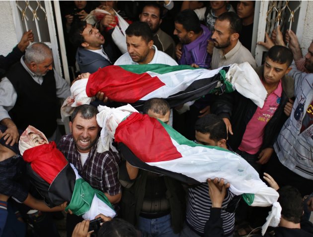 Palestinians carry the bodies …