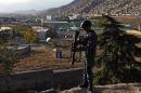 An Afghan policeman stands guard near the premises where the forthcoming Loya Jirga will be held in Kabul on November 19, 2013