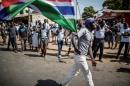 A man waves a Gambian flag while he celebrates the victory of Gambia's opposition candidate Adama Barrow during the Presidential Elections on December 2, 2016, in Serekunda, Banjul