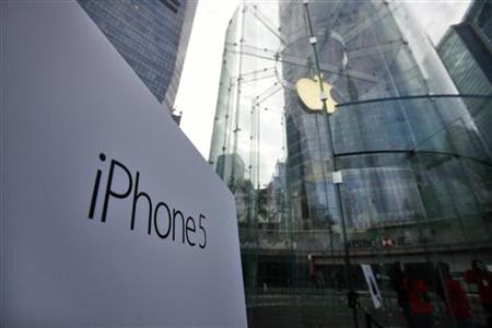 A sign of the new iPhone 5 is seen at the entrance of an Apple Store in the financial district of Pudong in Shanghai December 14, 2012. REUTERS/Carlos Barria
