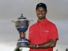 Tiger Woods holds the Gene Sarazen Cup for winning the Cadillac Championship golf tournament on Sunday, March 10, 2013, in Doral, Fla.  (AP Photo/Wilfredo Lee)