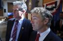 Sen. Rand Paul, R-Ky., right, and New Hampshire Republican Senate hopeful Scott Brown, left, speak to reporters after Paul endorsed Brown for the U.S. Senate during a campaign event at the University of New Hampshire in Durham, N.H., Friday, Sept. 12, 2014. (AP Photo/Elise Amendola)