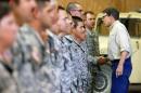 Gov. Rick Perry shakes hands with National Guard troops training at Camp Swift in Bastrop, Texas on Wednesday, Aug. 13, 2014. Perry visited some of the 1,000 troops he has ordered to the Texas-Mexico border but says he does not know how long they'll be deployed. (AP Photo/San Antonio Express-News, William Luther)