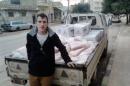 In this undated photo provided by the Kassig Family, Peter Kassig, is shown with a truck loaded with supplies. The Islamic State group released a graphic video on Sunday, Nov. 16, 2014, in which a black-clad militant claimed to have beheaded U.S. aid worker Peter Kassig, who was providing medical aid to Syrians fleeing the civil war when he was captured inside Syria on Oct. 1, 2013. His friends say he converted to Islam in captivity and took the first name Abdul-Rahman. (AP Photo/Courtesy Kassig Family)