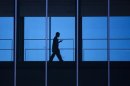 A student uses his mobile phone as he walks inside the Engineering building at the University of Waterloo