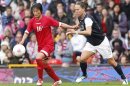 Lauren Cheney of the U.S. and North Korea's Kim Song-hui fight for the ball during their women's football first round Group G match at Old Trafford in Manchester during the London 2012 Olympic Games
