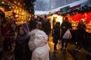 People shop at holiday vendors near Central Park in New York