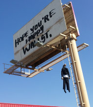 This image provided by KVVU-TV shows a billboard with a mannequin dangling from a hangman's noose near The Strip in Las Vegas. Authorities said calls began coming in early Wednesday Aug. 8, 2012, from drivers worried the dummy along Interstate 15 near was a real person. A Nevada Highway Patrol spokesman said the sign is a publicity stunt done in bad taste. A woman who answered the phone at Lamar Advertising Co. says the sign was not authorized and was being removed. (AP Photo/KVVU, Peter Dawson)