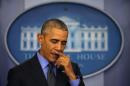 Obama pauses as he holds his end of the year news conference at the White House in Washington