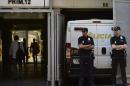 Spanish police stand guard as a police van carrying the parents of cancer patient Ashya King, 5, arrives at the courthouse in Madrid on September 1, 2014