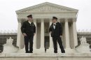 Two policemen talk in front of the U.S. Supreme Court in Washington