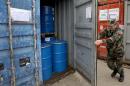 An Albanian soldier closes the door of a container housing 100 tonnes of newly-repackaged hazardous chemical waste at the military base of Qafe Molle near the capital Tirana on November 20, 2013