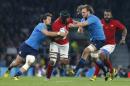 France's captain Thierry Dusautoir, center, is tackled by Italy's Josh Furno, right, during their Rugby World Cup Pool D match between France and Italy at Twickenham stadium in London, Saturday, Sept. 19, 2015. (AP Photo/Christophe Ena)