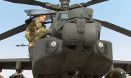 In this image from video, Britain's Prince Harry is shown an Apache helicopter by a member of his squadron, obscured behind, (name not provided) at Camp Bastion in Afghanistan, Friday Sept. 7, 2012. Prince Harry will be based at Camp Bastion during his tour of duty as a co-pilot gunner, returning to Afghanistan to fly attack helicopters in the fight against the Taliban. (AP Photo/TV Pool)