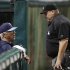 Tampa Bay Rays manager Joe Maddon, left,  talks with home plate umpire Fieldin Culbreth about the rain falling in the second inning of a baseball game, Friday, May 31, 2013, in Cleveland. The game was delayed shortly thereafter. (AP Photo/Tony Dejak)