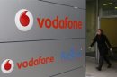 A woman walks past the logo of Vodafone company in Luxembourg in this picture taken on November 20, 2012. REUTERS/Francois Lenoir