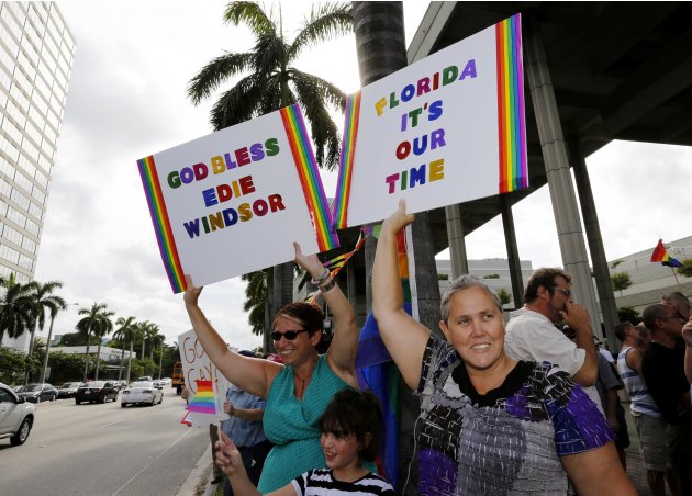 People hold signs at a gay rights rally following the U.S. Supreme Court strike down of the Defense of Marriage Act, in Fort Lauderdale