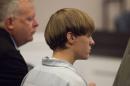 Dylann Roof, charged with murdering nine worshippers at a historic black church in Charleston last month, listens to the proceedings with assistant defense attorney William Maguire during a hearing at the Judicial Center in Charleston