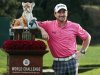 Graeme McDowell poses with the trophy after winning the World Challenge golf tournament at Sherwood Country Club in Thousand Oaks, Calif., Sunday, Dec. 2, 2012. (AP Photo/Bret Hartman)