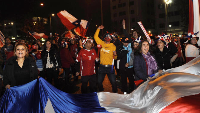 Fans of Chile&#39;s national soccer celebrate their team&#39;s victory over Peru during the Copa America semifinal soccer match, in Santiago, Chile, Monday, June 29, 2015. Chile won the match 2-1. (AP Photo/Victor Ruiz)