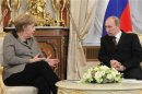 Russian President Putin walks tith German Chancellor Merkel during their meeting in Moscow's Kremlin